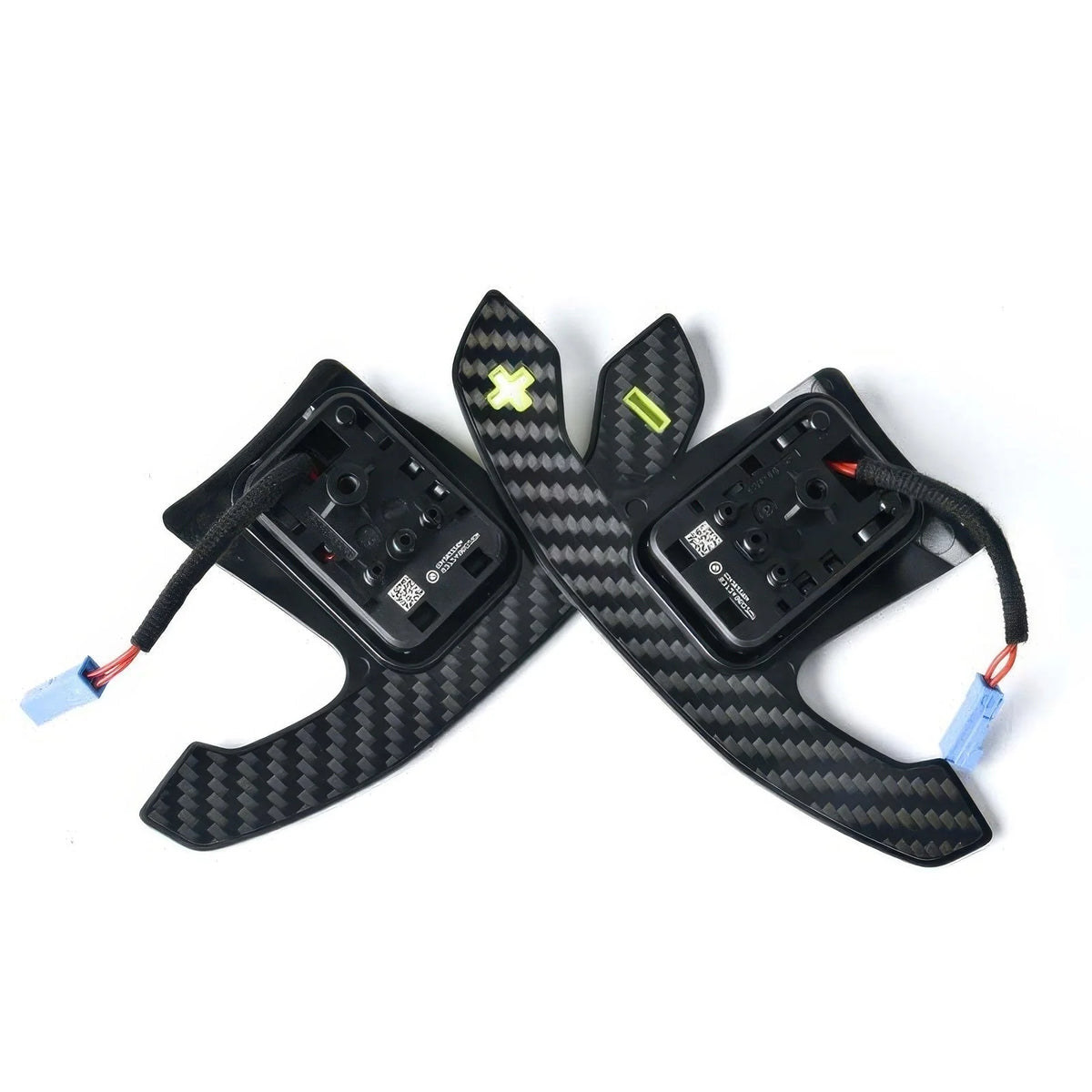 Angled view of carbon fiber paddle shifters with yellow symbols and wiring