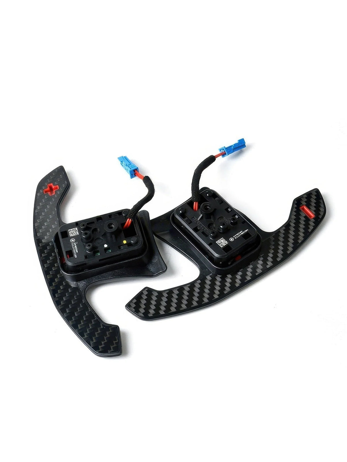 Angled view of carbon fiber paddle shifters with red symbols and wiring connectors